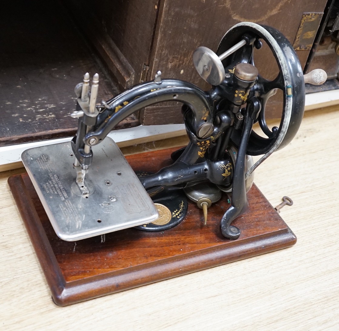 Two cased vintage portable sewing machines, Willcox and Gibbs, 32cms wide